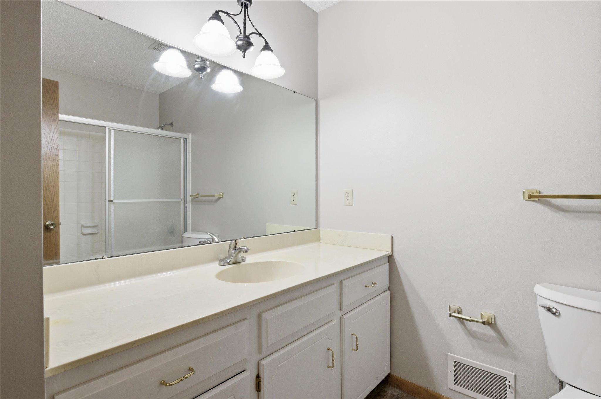 Bright and functional, the upper-level full bathroom offers convenience for family and guests alike.