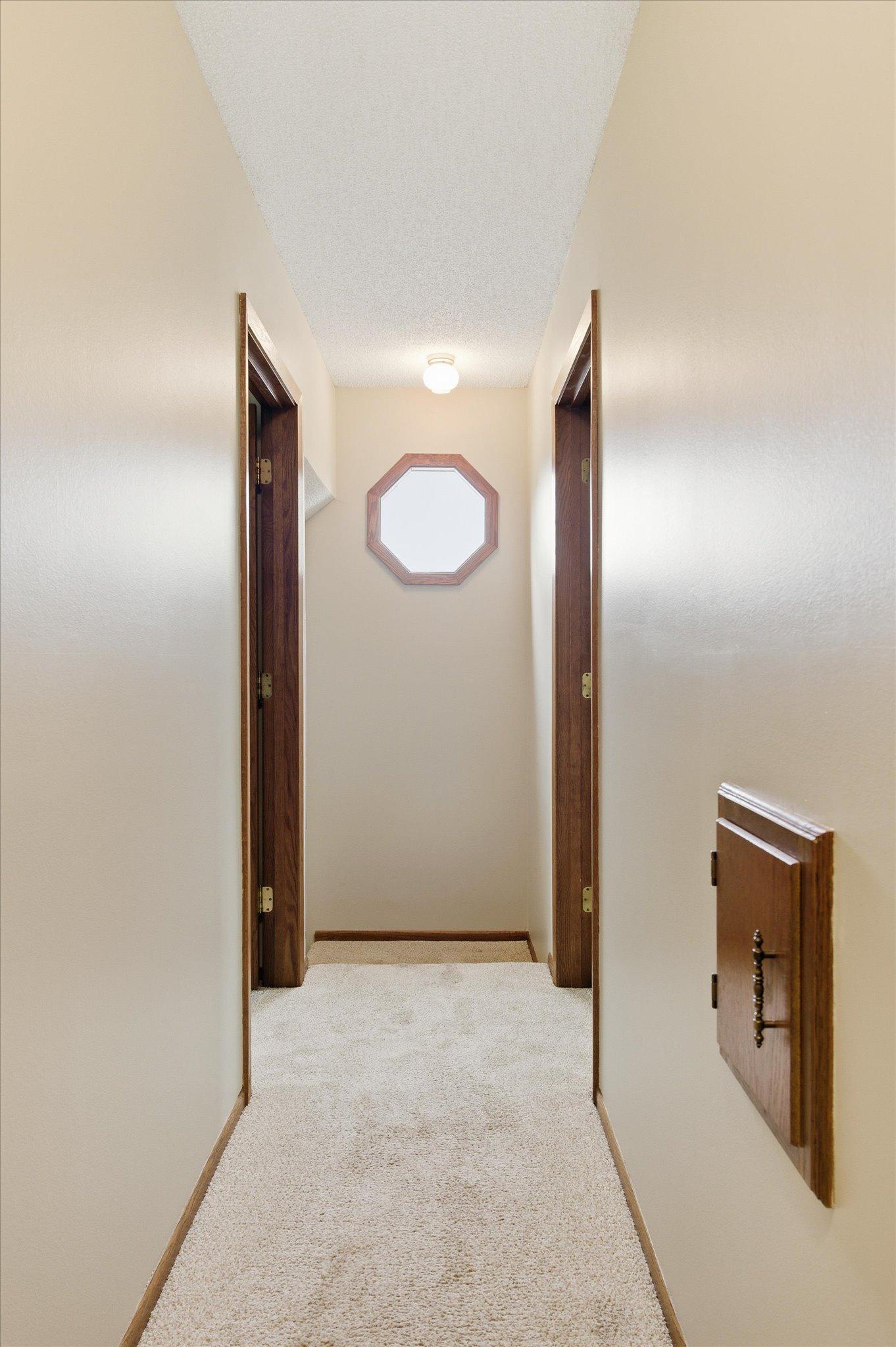 Upstairs, the hallway connects all four bedrooms while creating a comfortable and functional second-level layout.