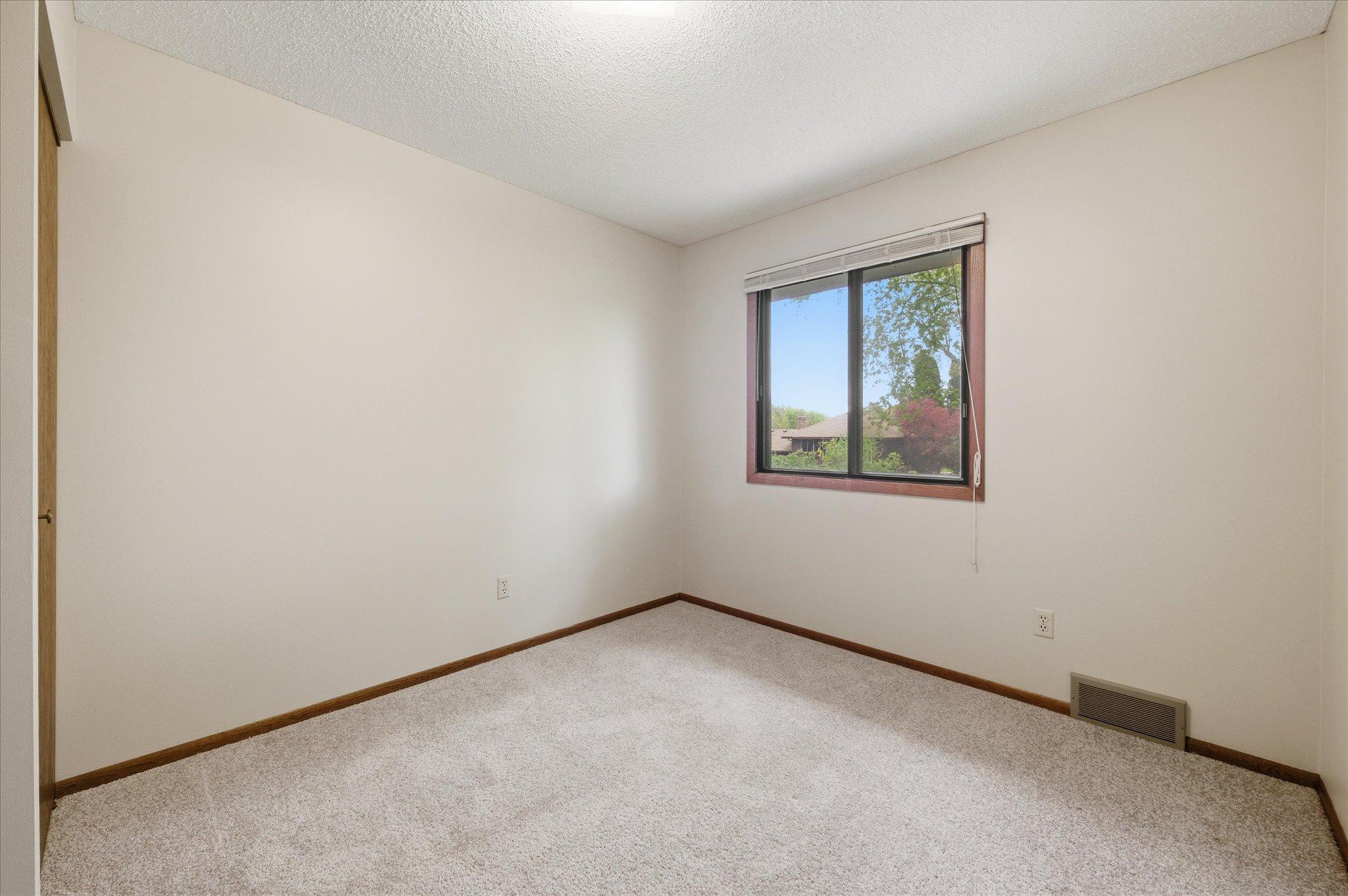 The three upper-level bedrooms each offer comfortable layouts, great natural light, and generous closet space. Whether used as bedrooms, guest rooms, office space, or hobby areas, these versatile rooms easily adapt to your needs.