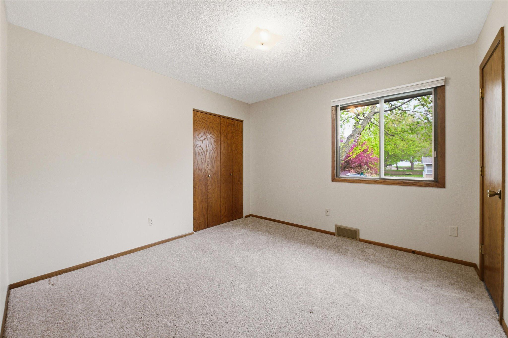 The three upper-level bedrooms each offer comfortable layouts, great natural light, and generous closet space. Whether used as bedrooms, guest rooms, office space, or hobby areas, these versatile rooms easily adapt to your needs.