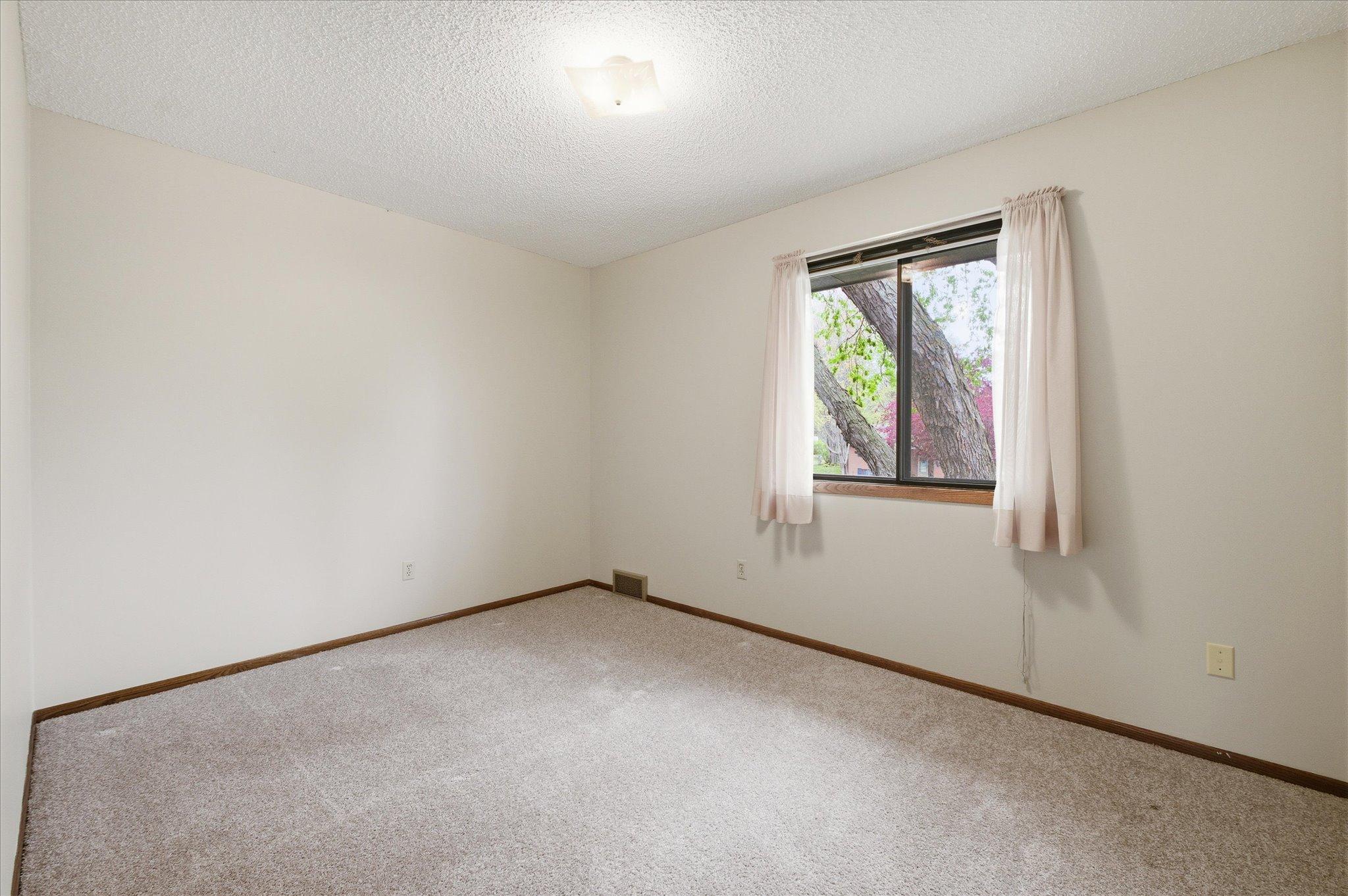 The three upper-level bedrooms each offer comfortable layouts, great natural light, and generous closet space. Whether used as bedrooms, guest rooms, office space, or hobby areas, these versatile rooms easily adapt to your needs.