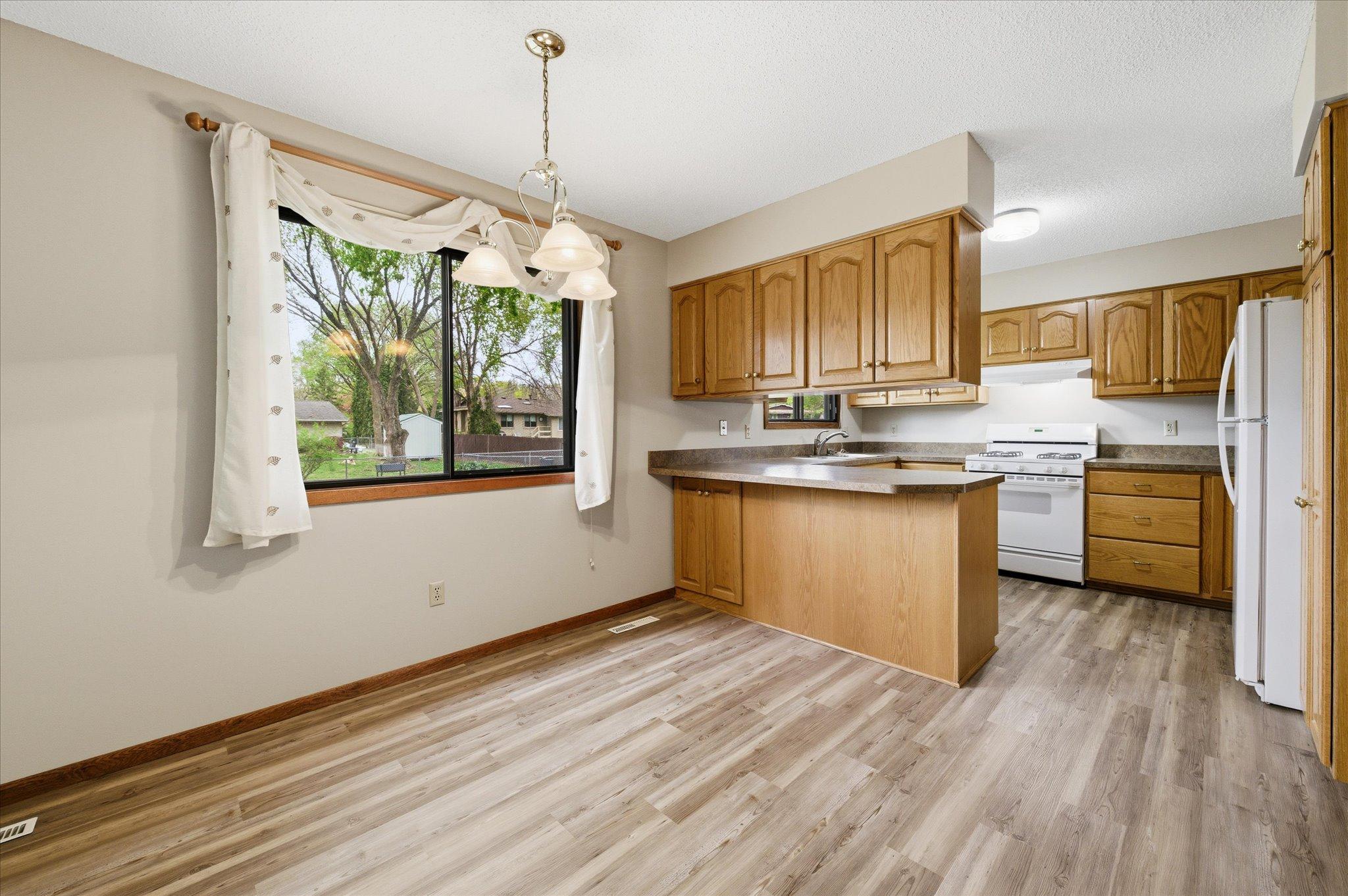 This dining area offers a cozy and intimate setting for weeknight dinners, morning coffee, or holiday gatherings. Conveniently located beside the kitchen, it creates a comfortable space where everyday moments feel extra special.
