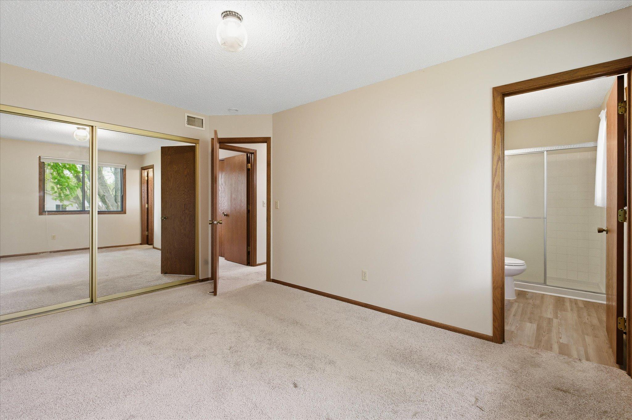 One more thing to love about the primary suite is the ample mirrored closet space paired with its private ensuite bathroom.