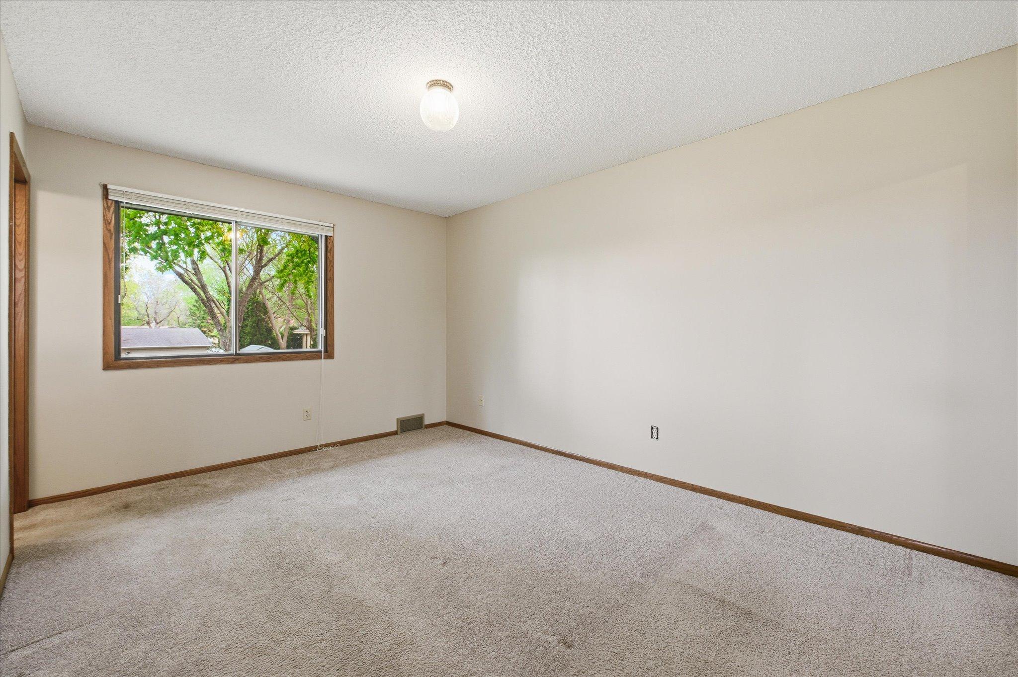 The spacious primary bedroom creates a relaxing retreat at the end of the day with room for larger furniture and additional seating if desired.