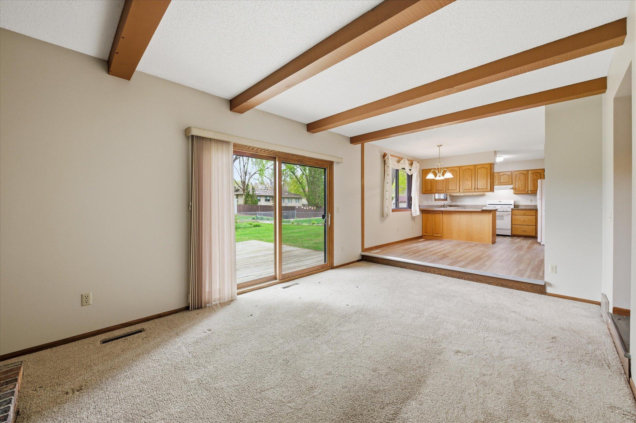The open-concept family room flows seamlessly into the kitchen and dining area, making gatherings feel easy and connected. Whether entertaining guests or spending quiet evenings at home, this layout was designed for everyday enjoyment.