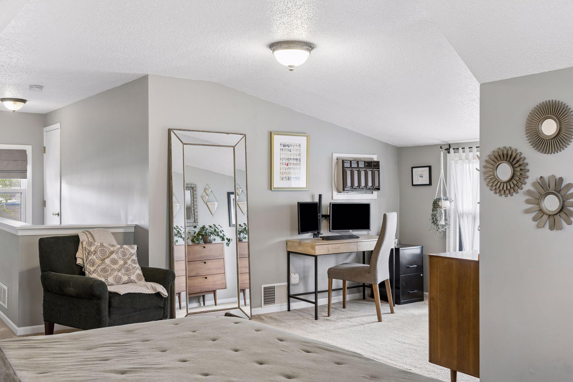 Upper level primary suite offers room for office or lounge