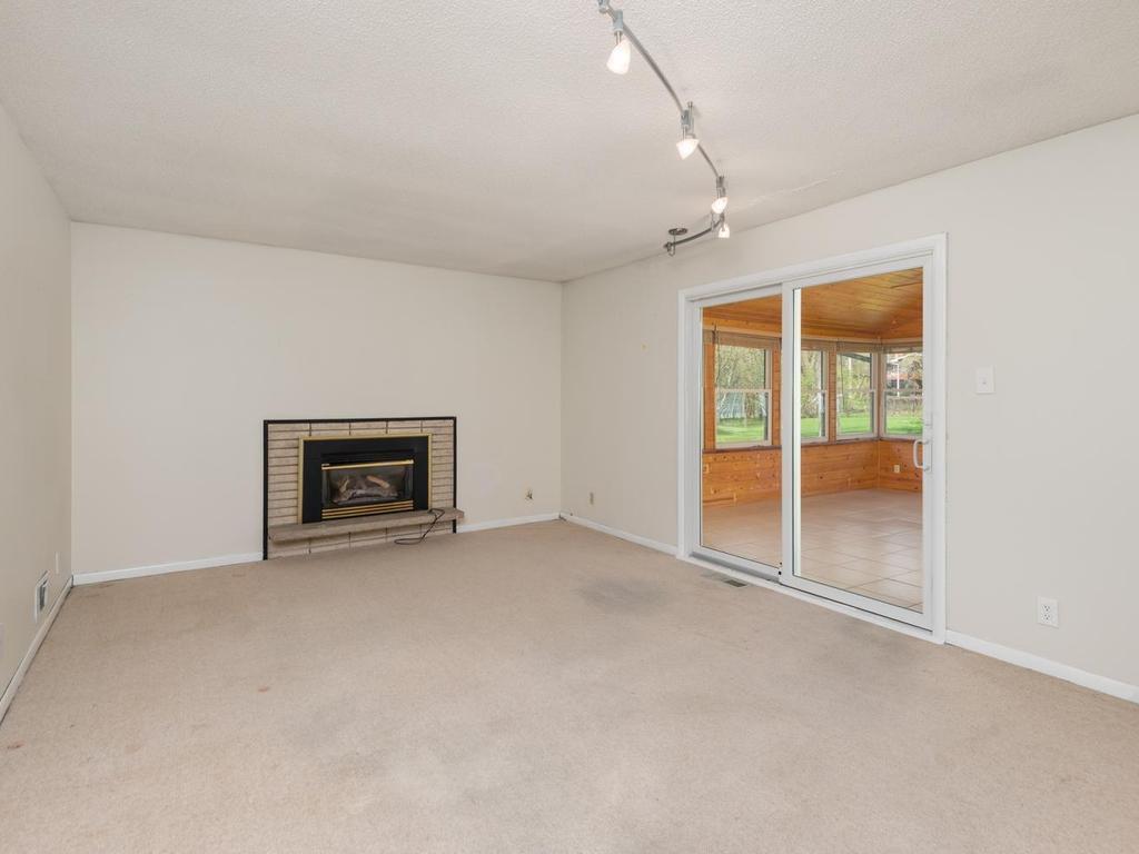 Main level Family Room has patio door to Sunroom