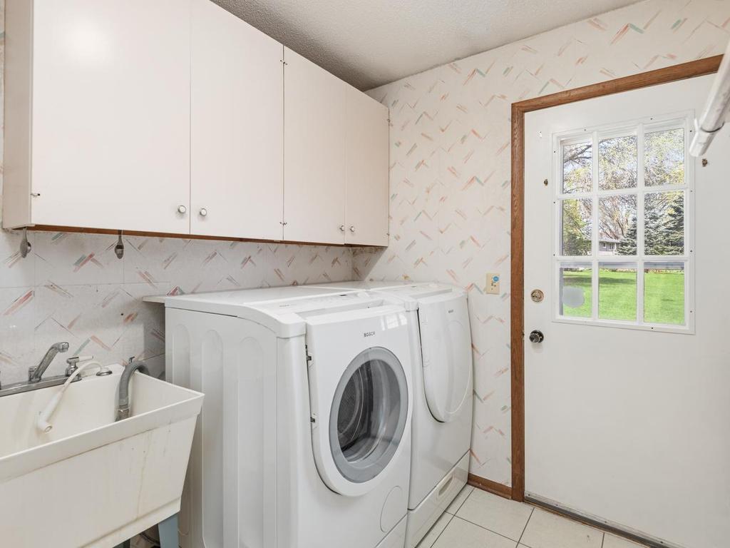 Main level Laundry Room with exterior access to the deck and backyard.