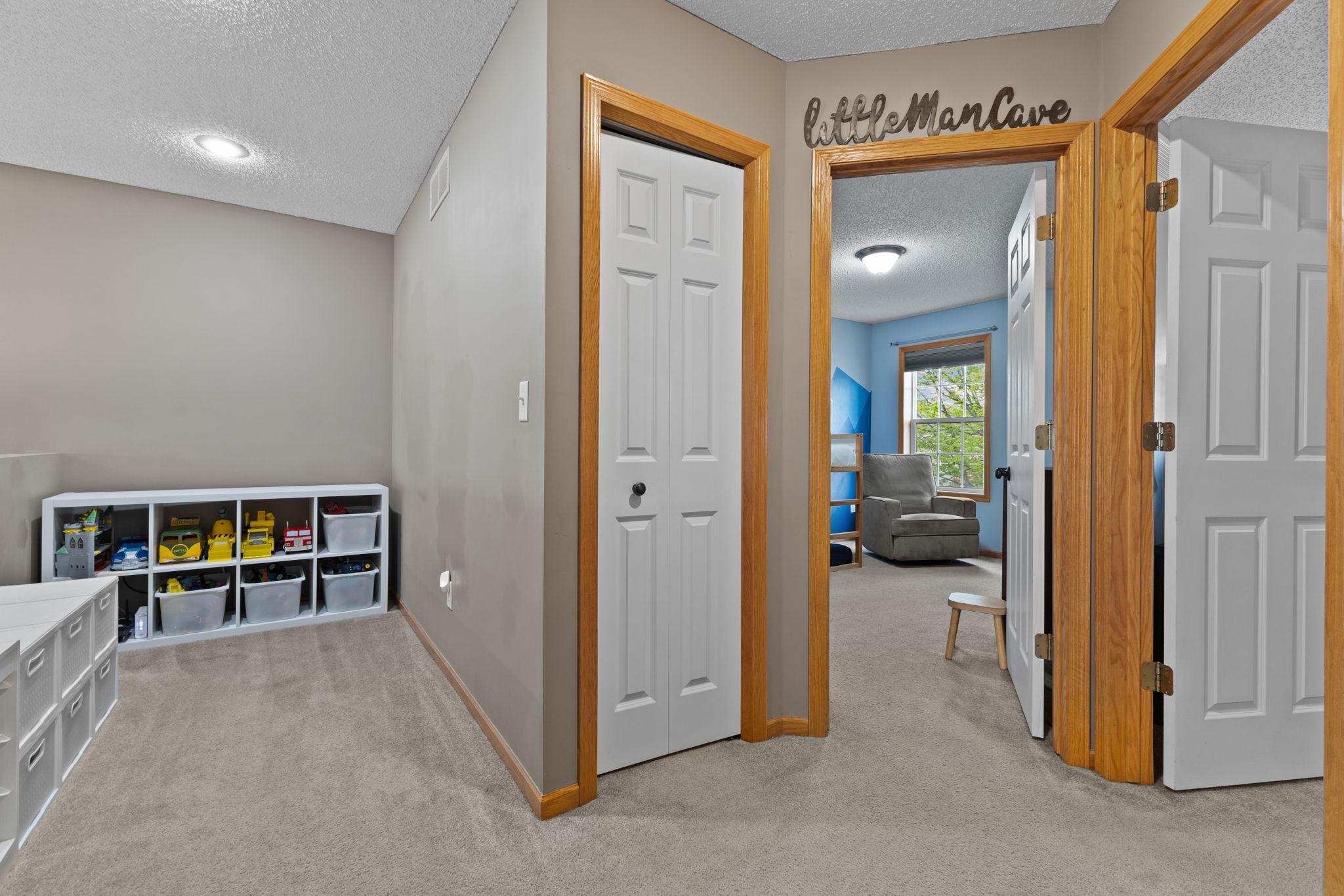 The bifold door is a linen closet. There are two bedrooms on this level. The door to the far right is the primary bedroom.