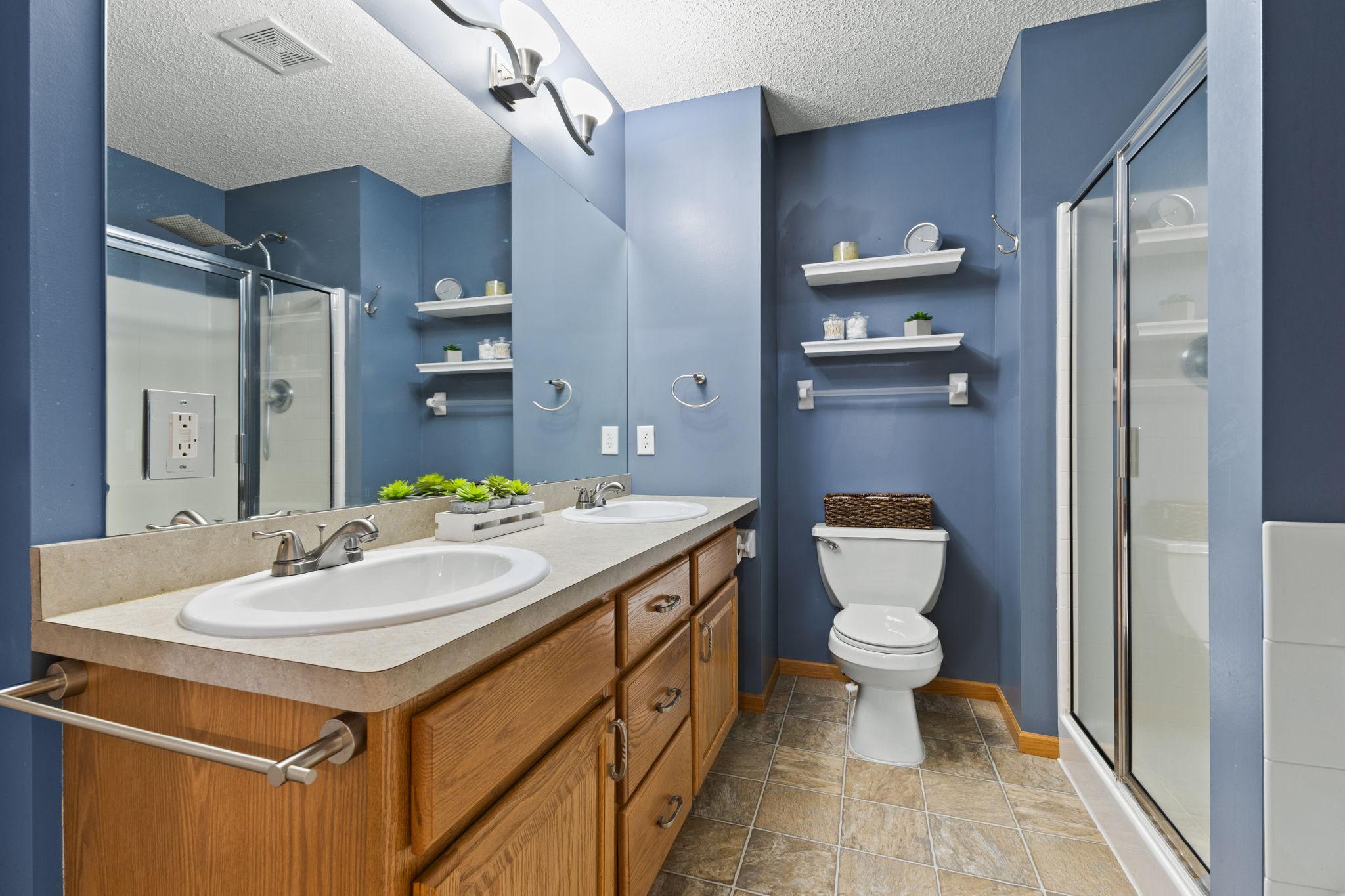 This is the upper level bathroom. Generously sized with a solid amount of storage space.
