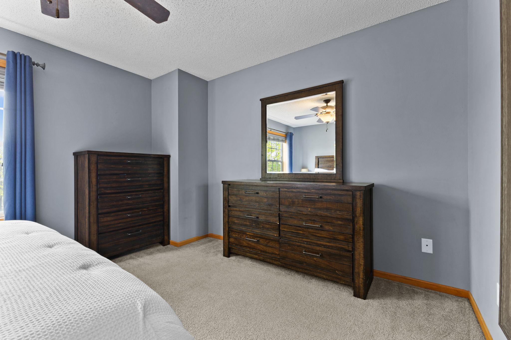Primary bedroom with a walk in closet.