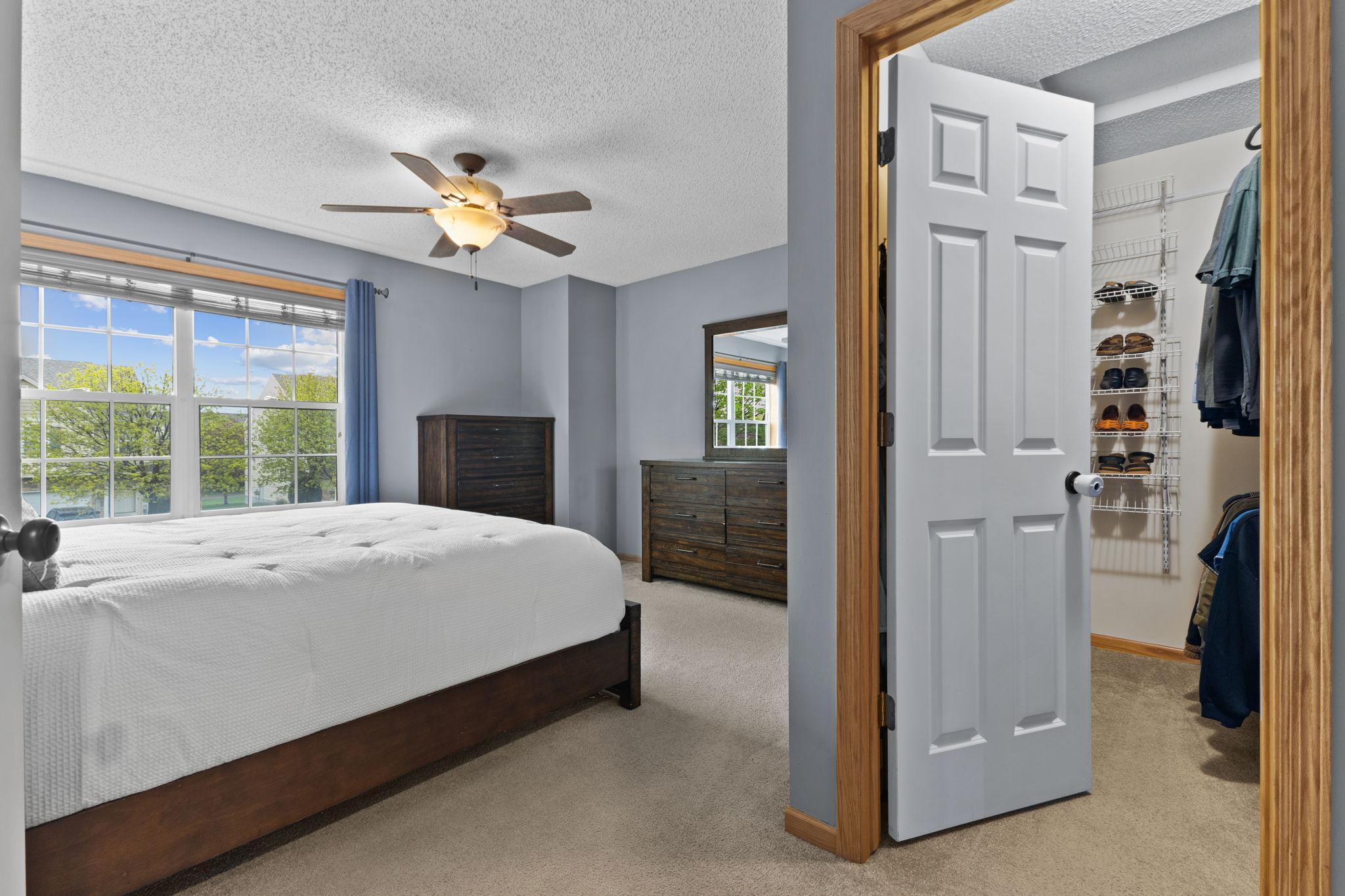 Primary walk-in closet with some built in shelving. For size reference, the bed in the photos is a king size.