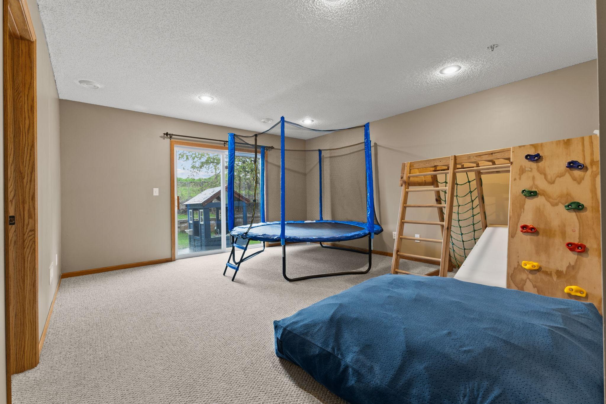This is the lower level walkout family room. Currently, it is used as a hangout space for the kids. The door to the left is the third bedroom.