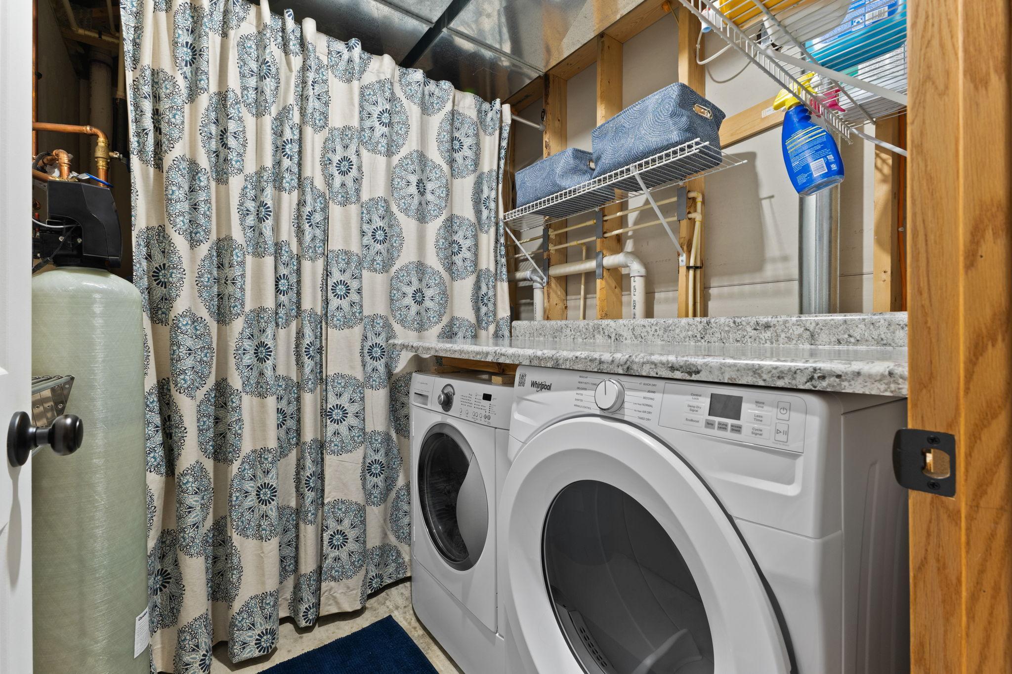 Laundry room with a countertop for convenience. The mechanicals are behind the curtain.