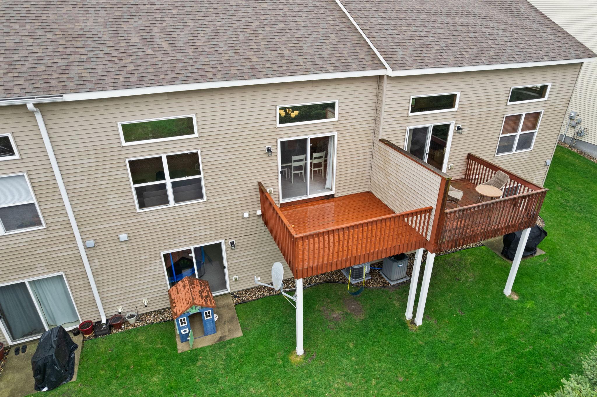 Newly stained back deck with a privacy wall.