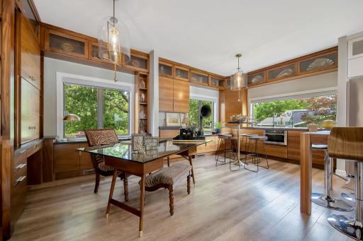 Office is surrounded w/ custom walnut cabinetry offering built in desk w/ doors that glide open for computer/printer. If wanted, space is left to install glass around the office to maintain the 360 degree views while at work. See renderings at home.