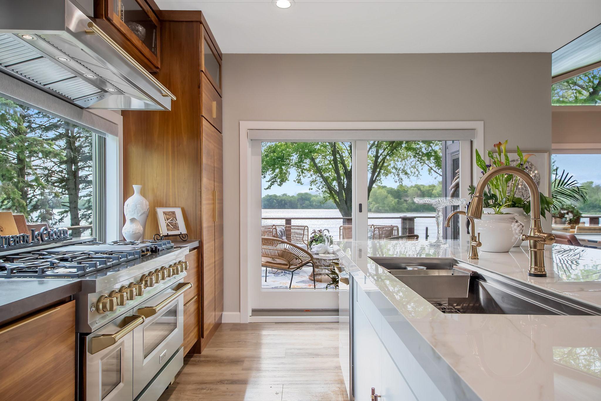 Kitchen features a 55" workstation sink, Delta touchless faucet and z-line appliances to include an 8 burner, double oven stove.