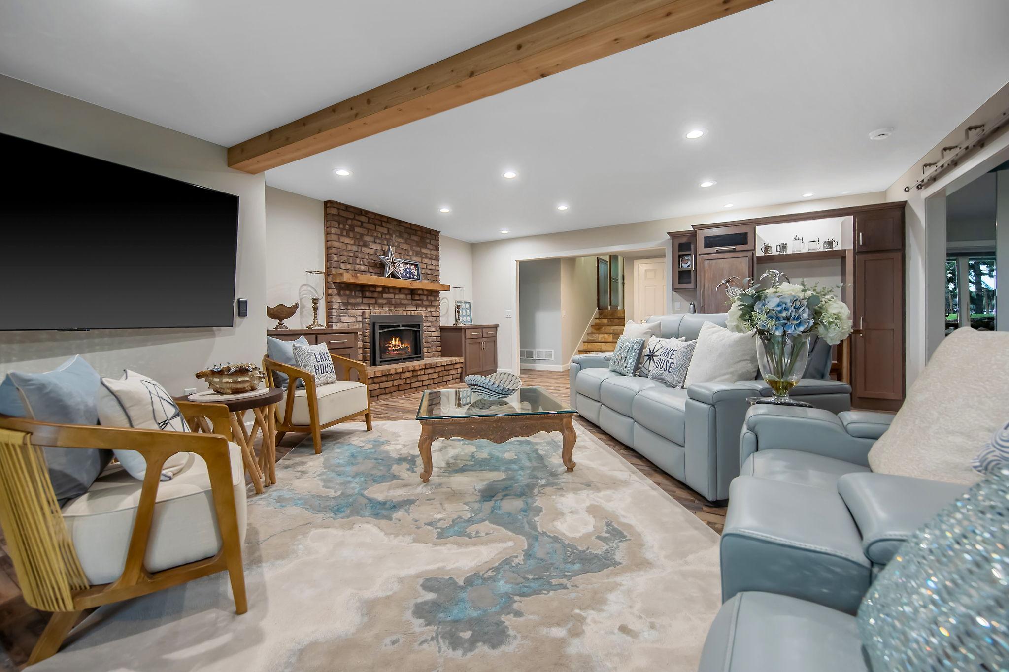 The spacious lower-level family room boasts sliding walkout doors that open to the 4 season porch. It is complete with a wet bar with refrigerator. After a busy day, take a dip in the hot then jump in the sauna!