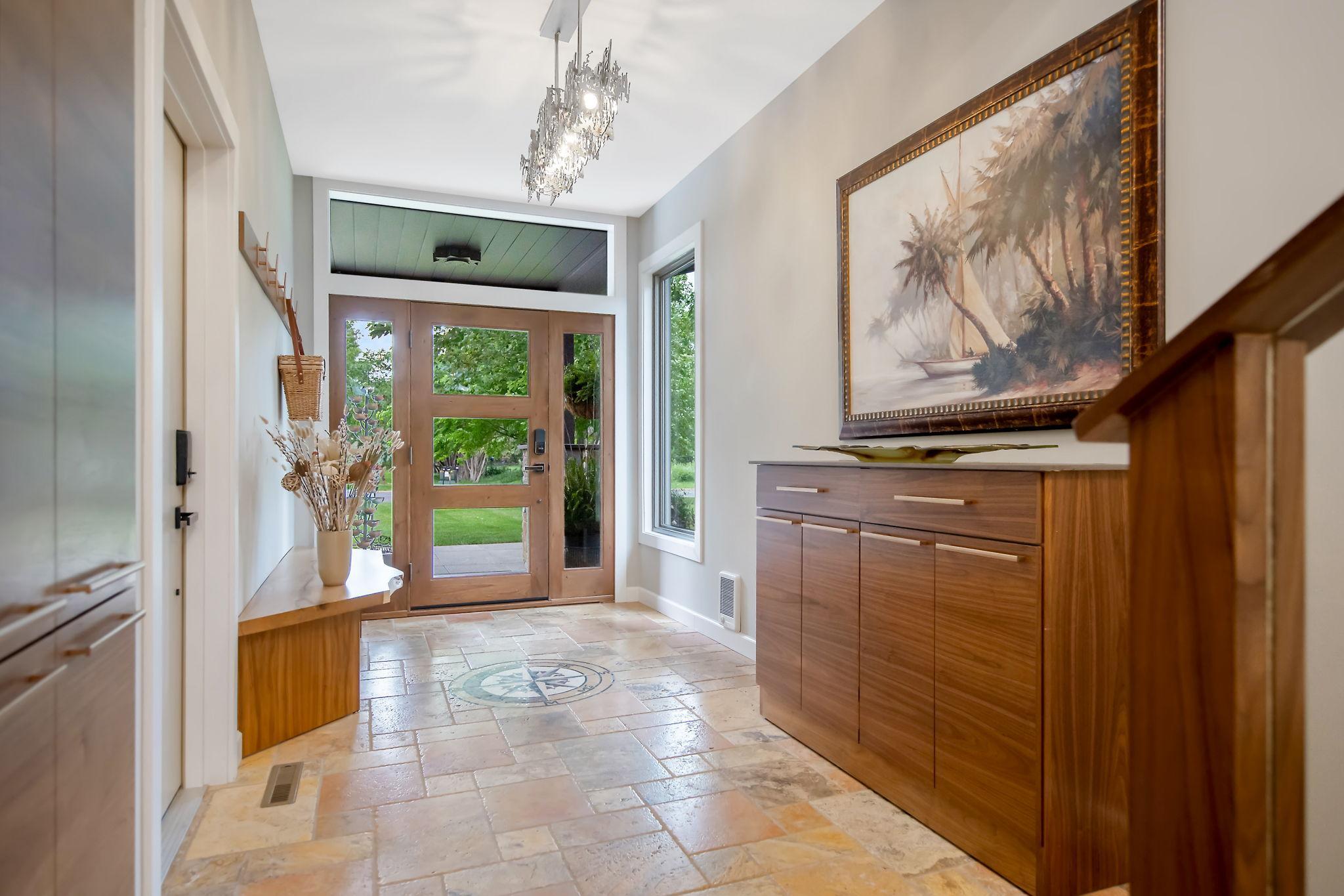 Foyer/Mudroom with marble compass and live edge bench custom made by a local artisan.