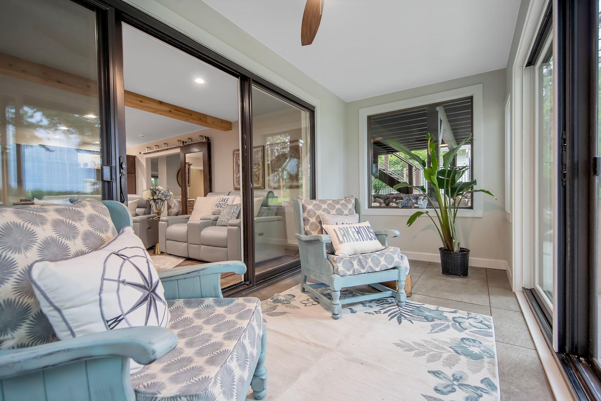 The four season porch has windows all around, a ceiling fan with sliding walkout doors leading to the hot tub/backyard.