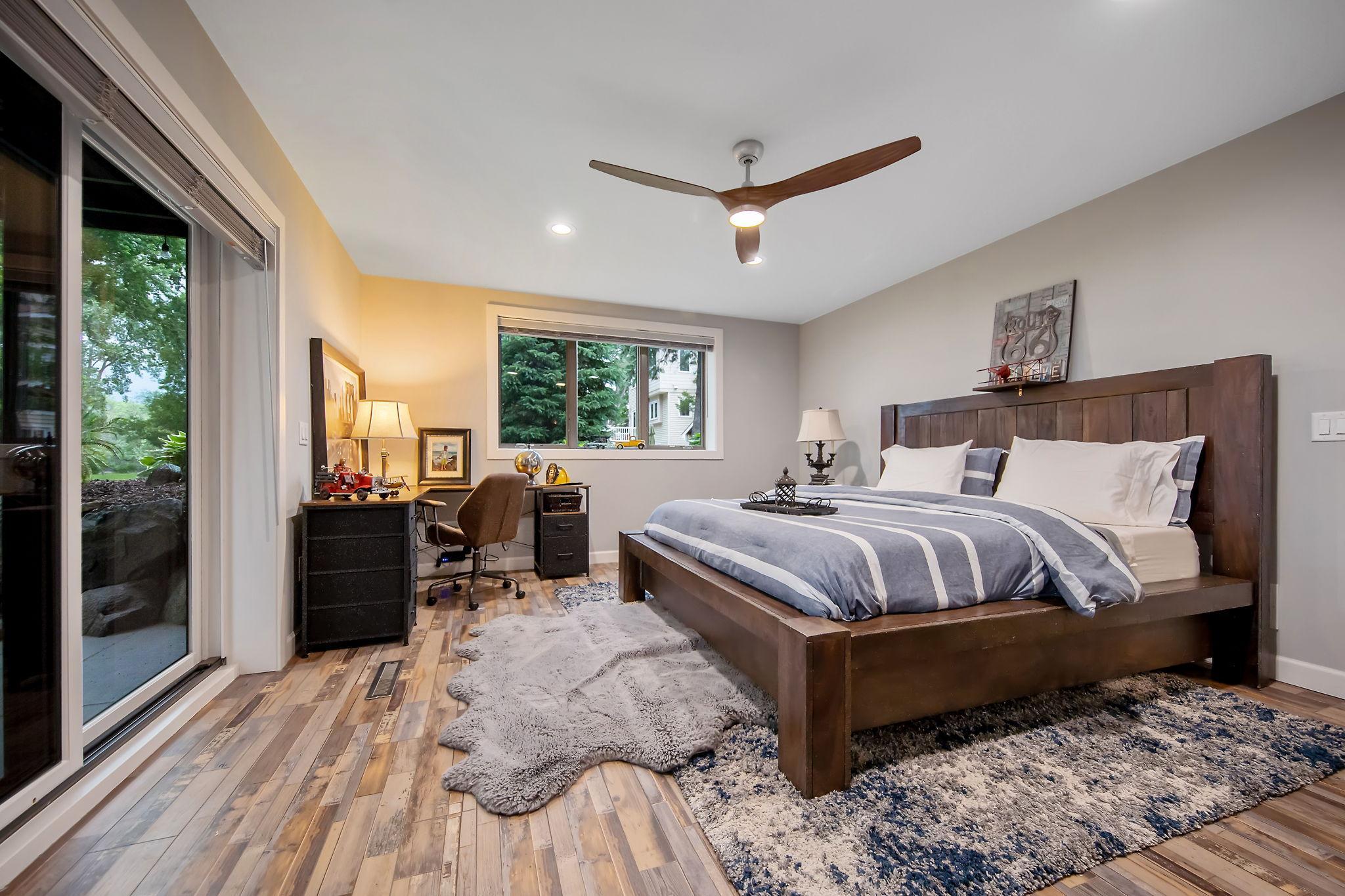 Second bedroom features electric fireplace and walkout to a 22'X16" covered patio with ceiling fan.