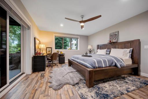 Second bedroom features electric fireplace and walkout to a 22'X16" covered patio with ceiling fan.