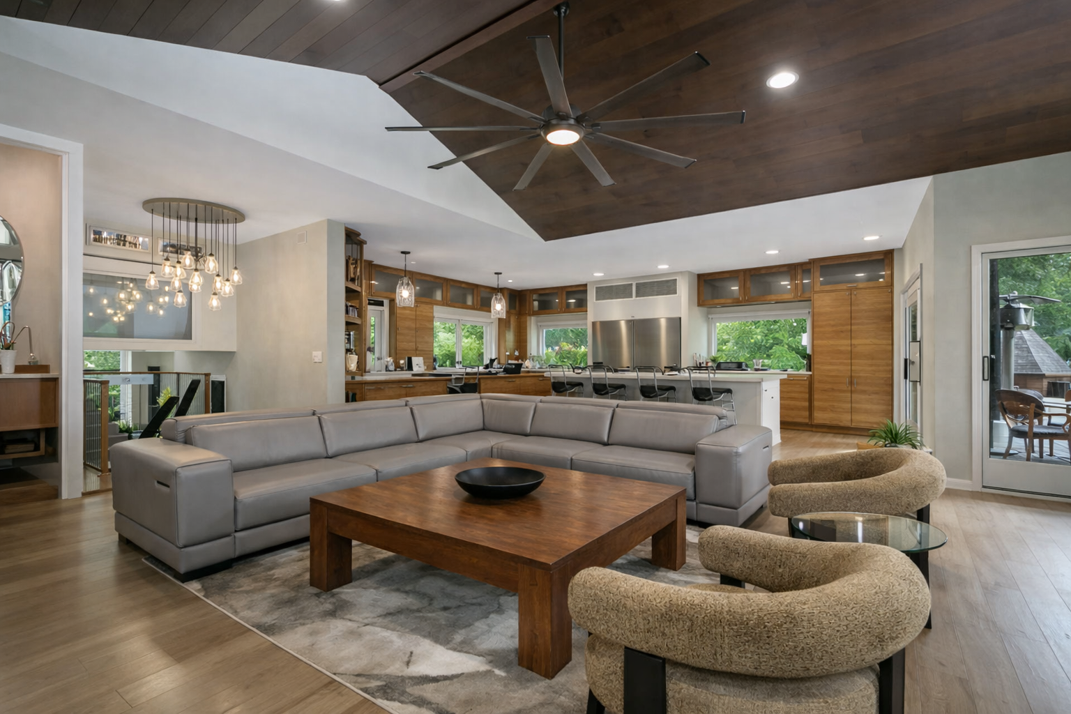 Custom made walnut cabinetry surround the main floor Great Room and is highlighted by Restoration Hardware Lighting.