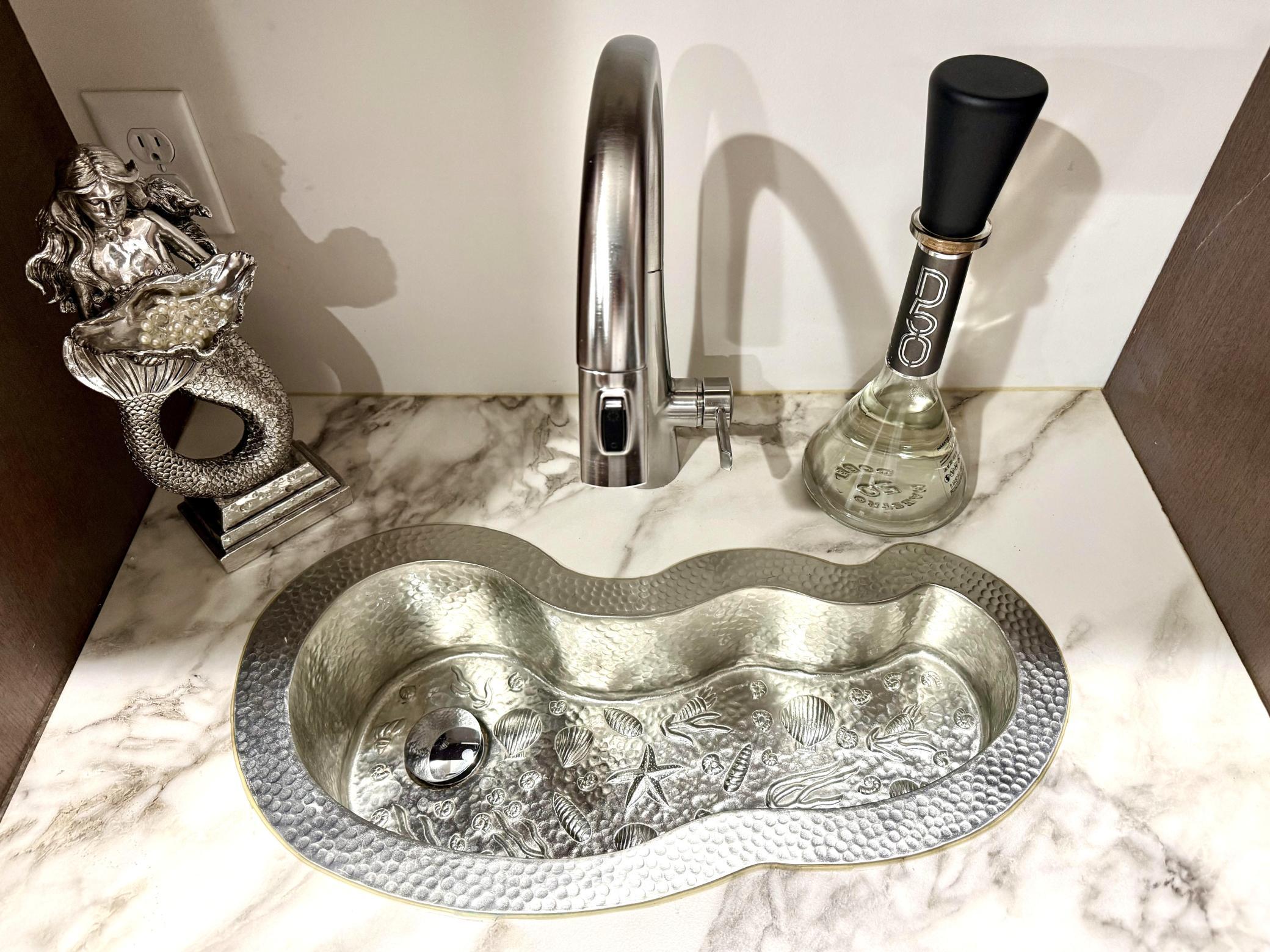 Imported handmade, hammered Copper Nickel Lower level bar sink with sea shell design.