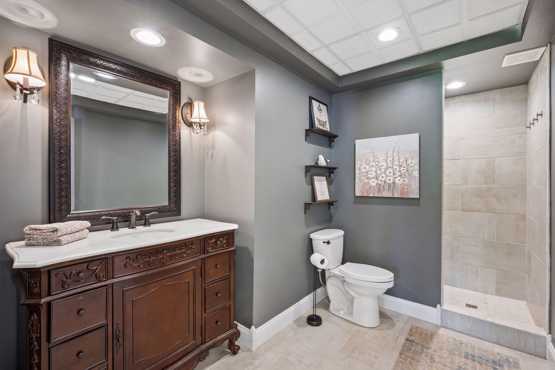Fully remodeled lower-level bath with step-in roman shower