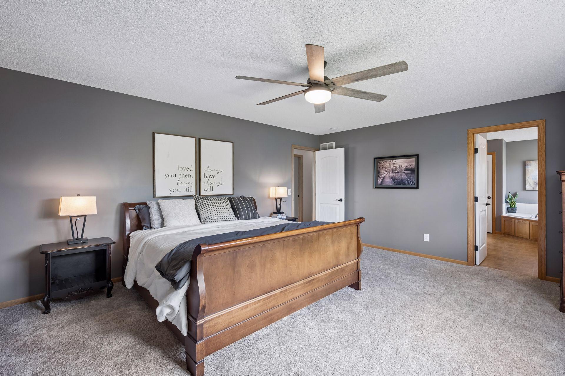 Spacious primary suite featuring generous room size, plush carpet, large walk-in closet and a private ensuite bath