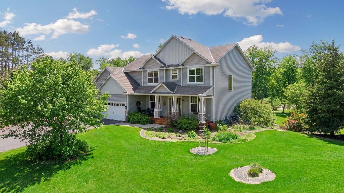Impressive custom two-story home nestled on a picturesque lot surrounded by mature trees and beautiful landscaping.