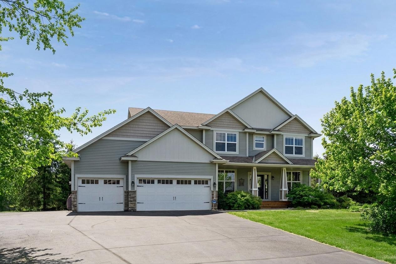 Impressive custom two-story home nestled on a picturesque lot surrounded by mature trees and beautiful landscaping.