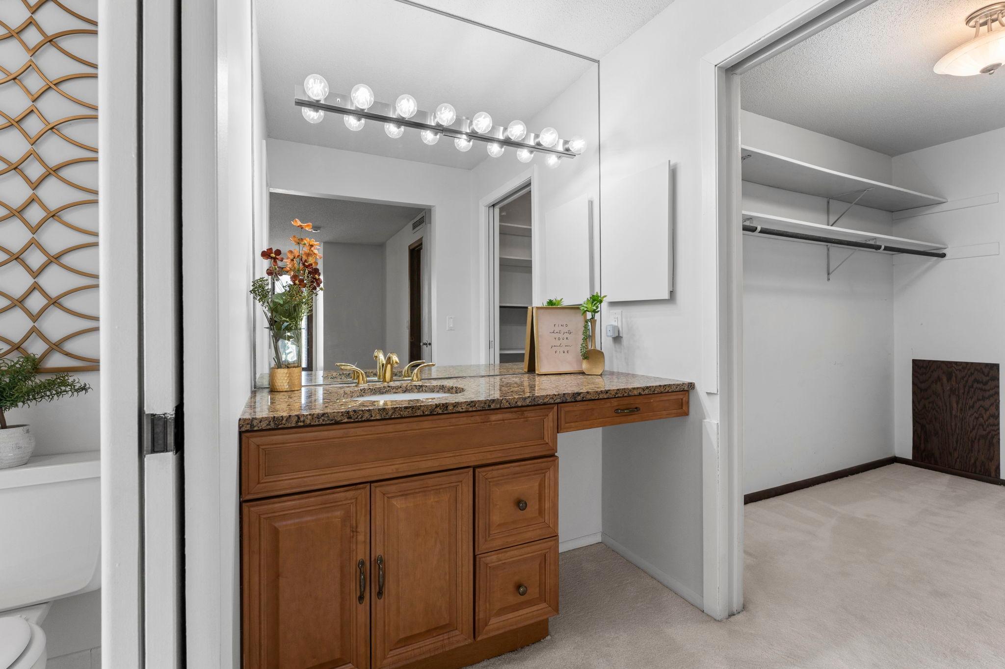 Primary bathroom sink and walk in closet