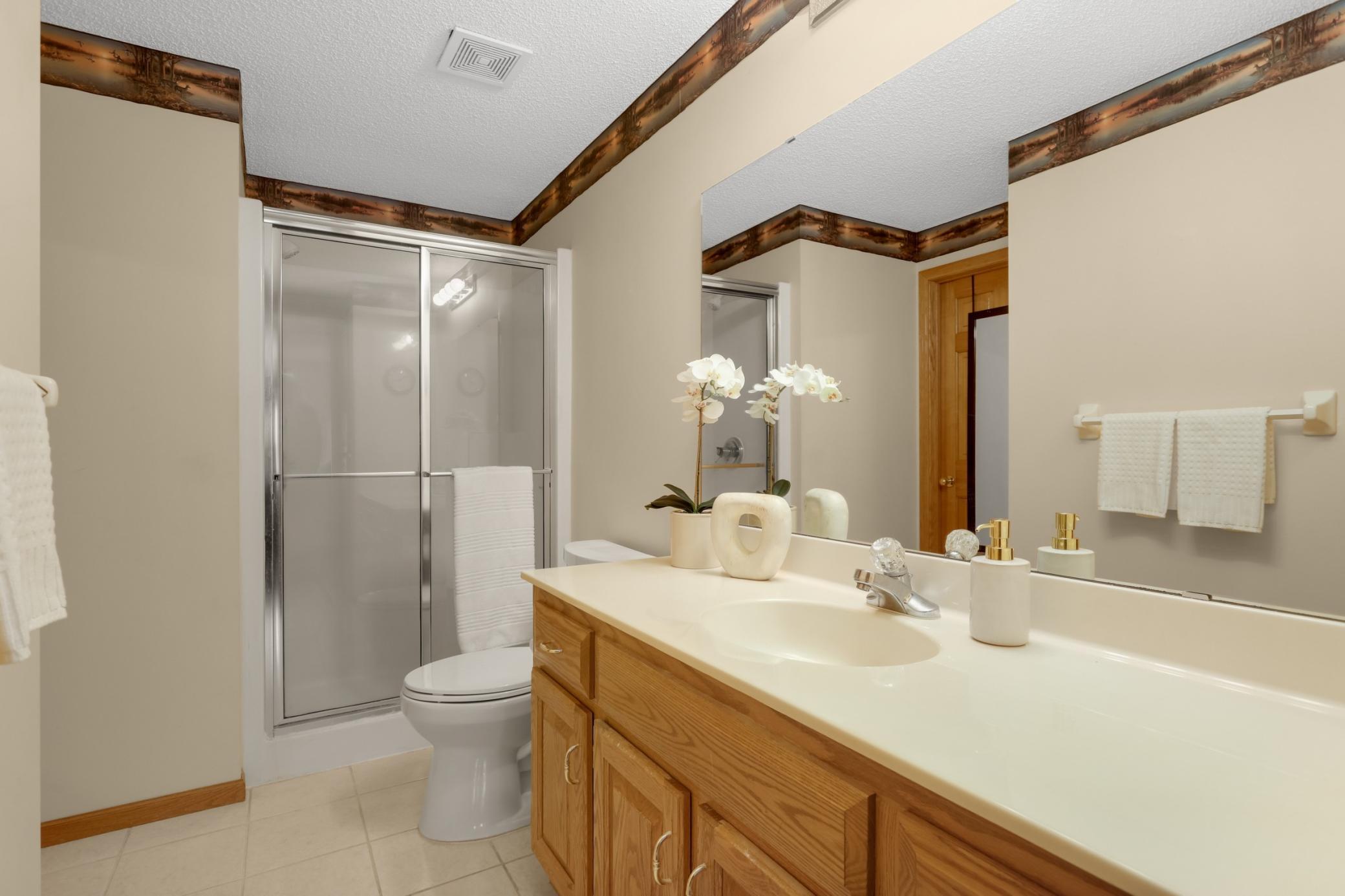 The lower level features a spacious three-quarter bathroom and plenty of storage.