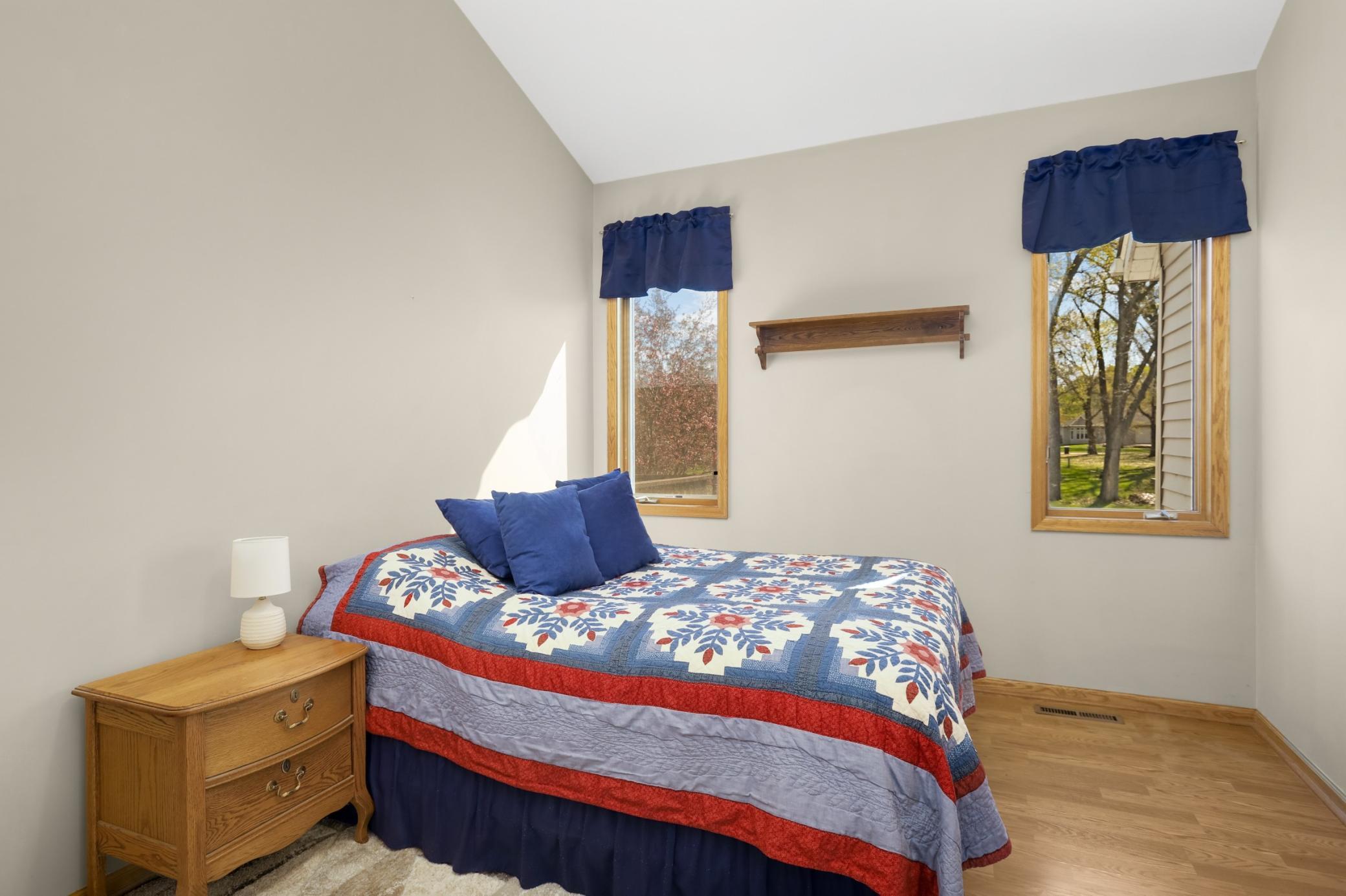 The main floor primary bedroom overlooks the lovely pond in the back of the home.