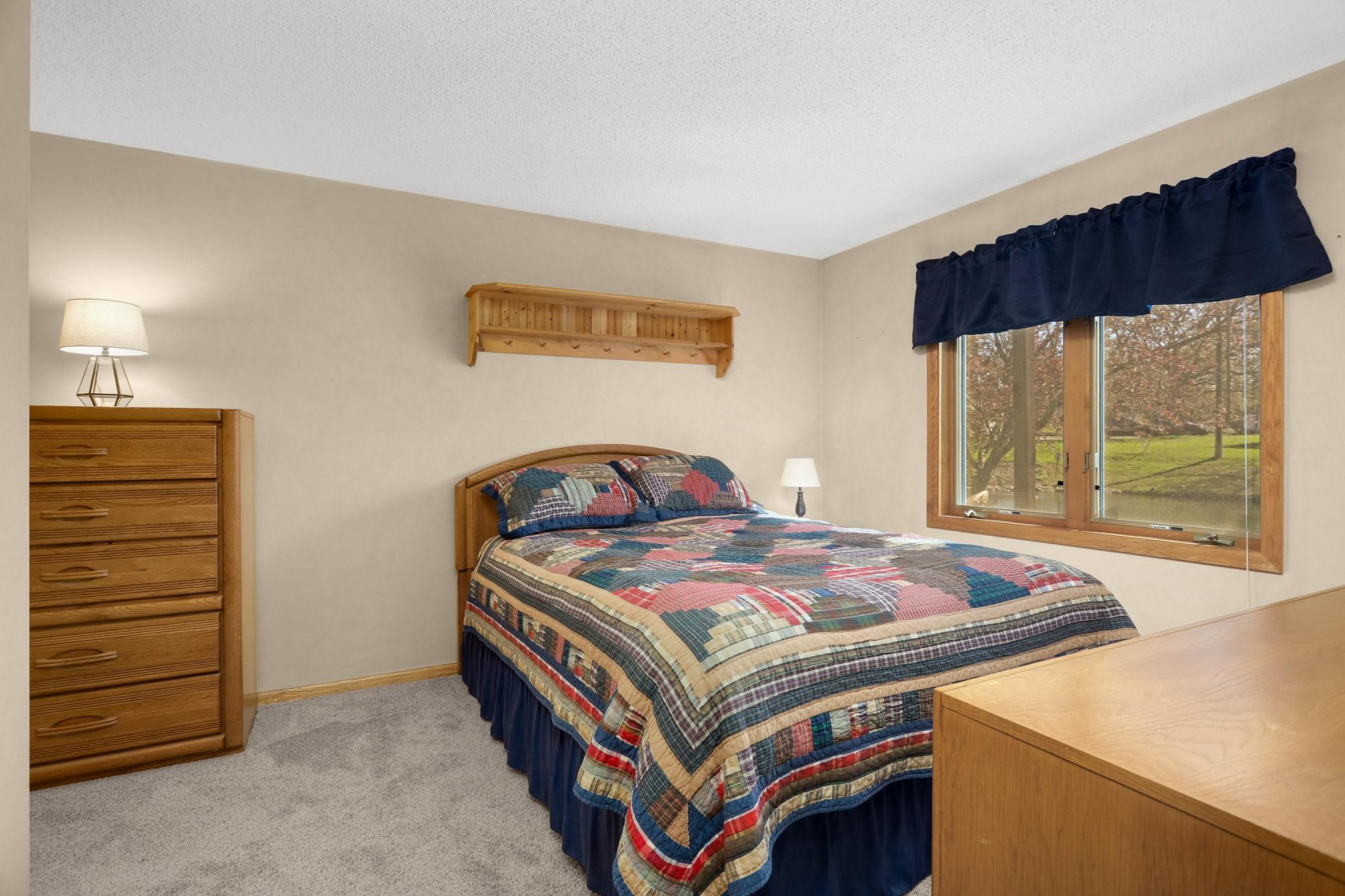 The lower-level bedroom also overlooks the tranquil pond in the back.