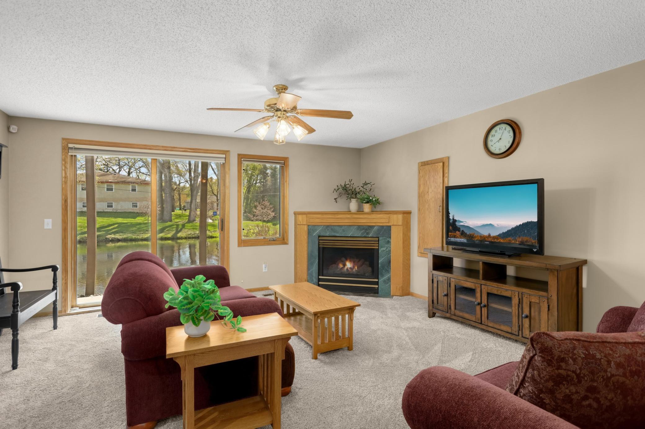 The walkout lower level features a beautiful gas fireplace and patio to sit and enjoy the pond.