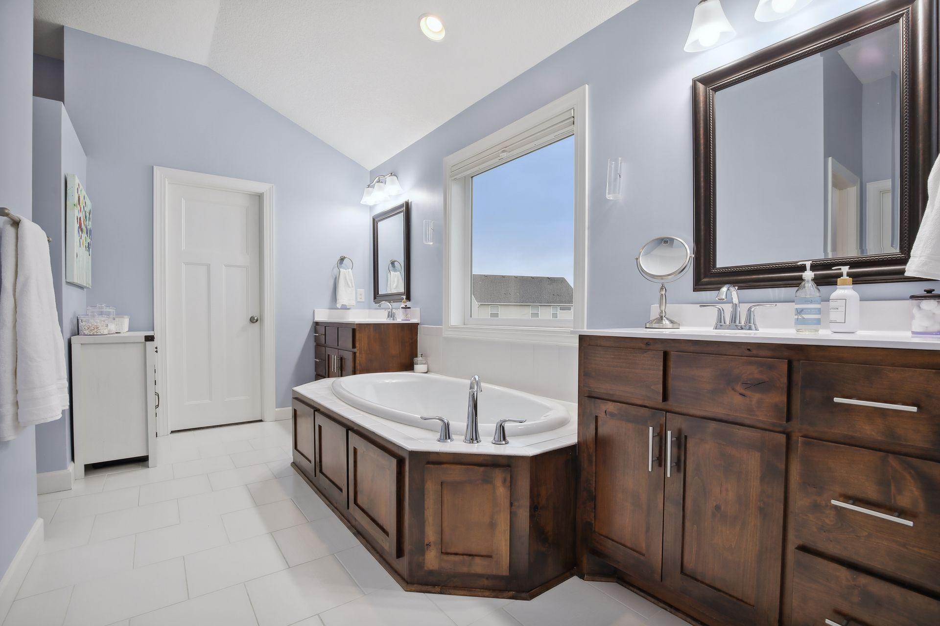 Large private bath off the primary suite has two additional walk-in closets, double vanity.