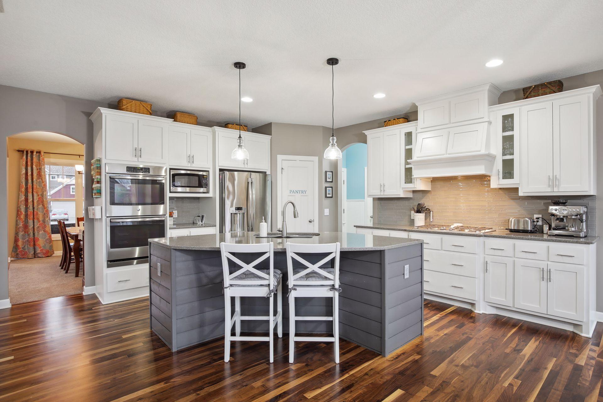 Stainless appliances include cooktop and wall oven.