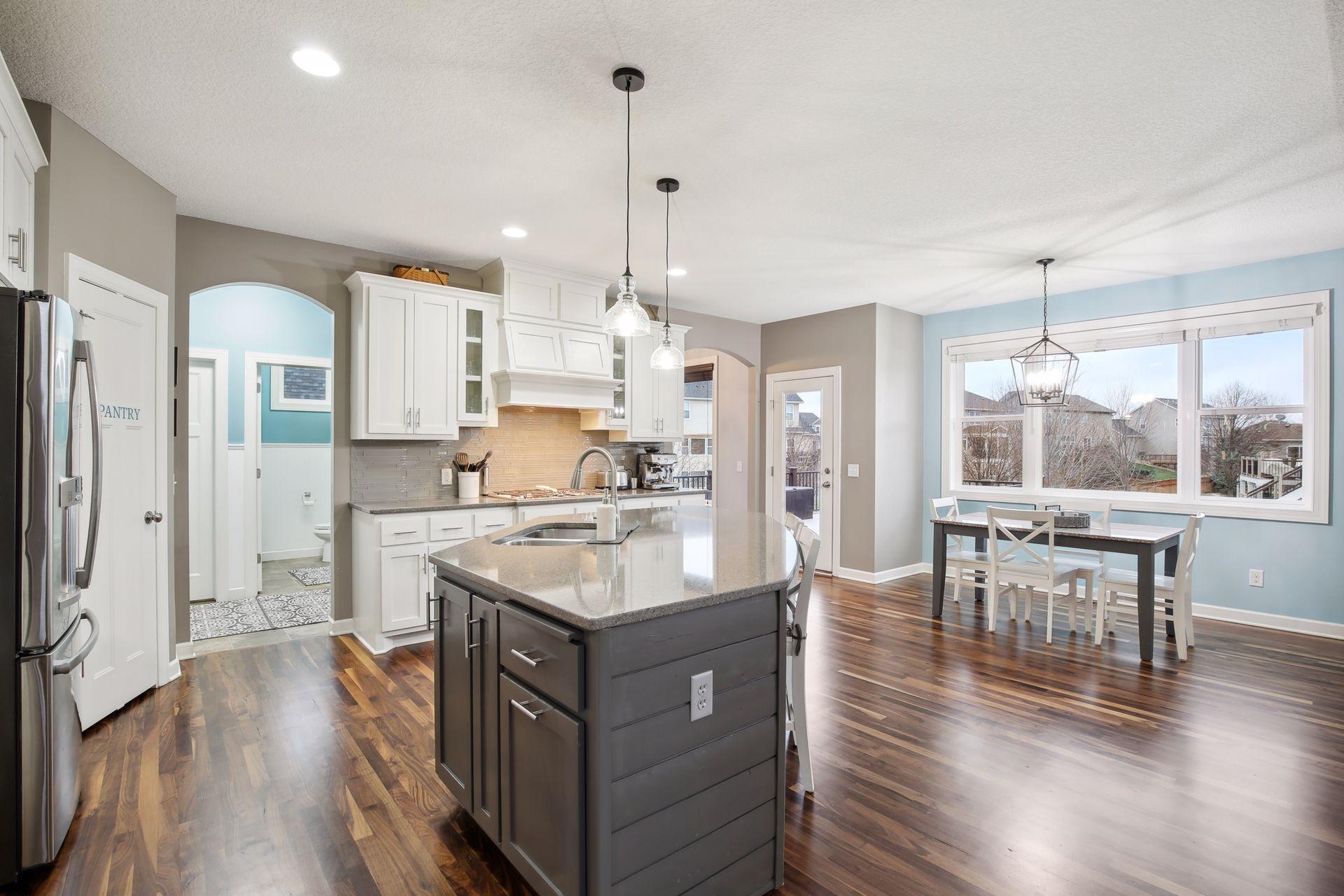 The kitchen is the heart of this home and opens to the mud room area as well as a sunroom overlooking the deck and backyard.