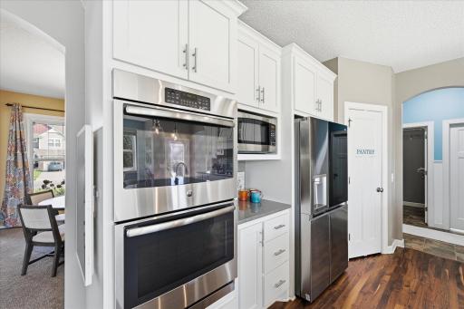 Stainless appliances include dual wall ovens, microwave above a coffee nook and a new fridge that makes a variety of ice including craft round ice cubes for enjoyable beverage options.