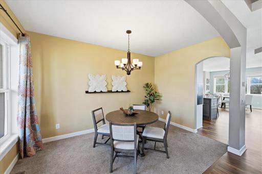 Formal dining opens to the foyer, kitchen and living spaces.