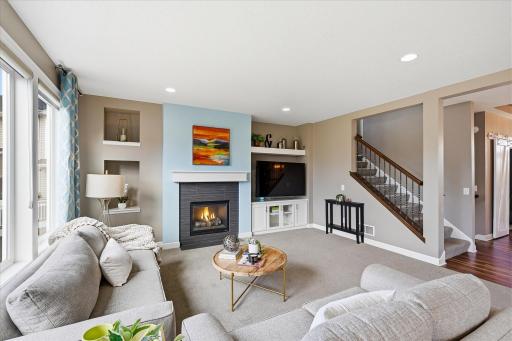 Built in entertainment center, gas fireplace and attractive open railing system give this room an upscale look.