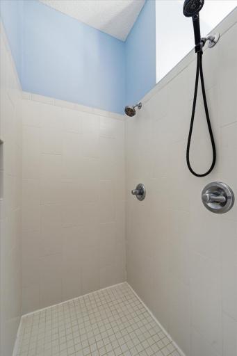 Dual shower head in this generously sized walk-in shower
