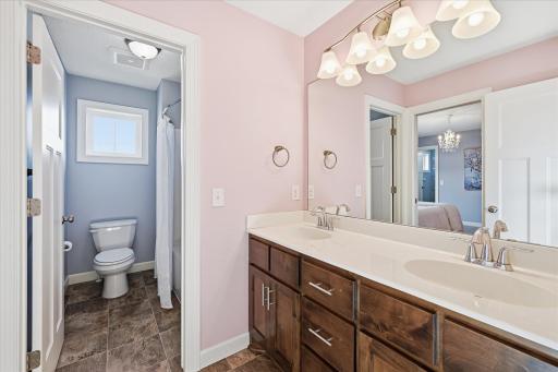Jack and Jill bath has separate room for tub/shower and stool