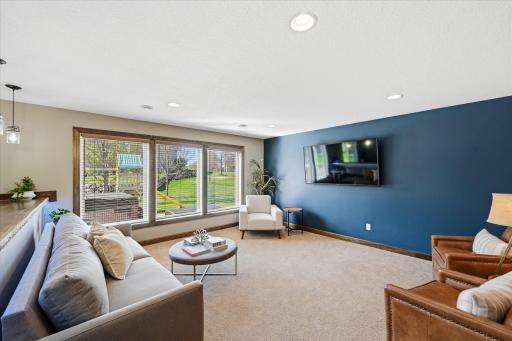 Spacious lower level walkout family room with wall of windows