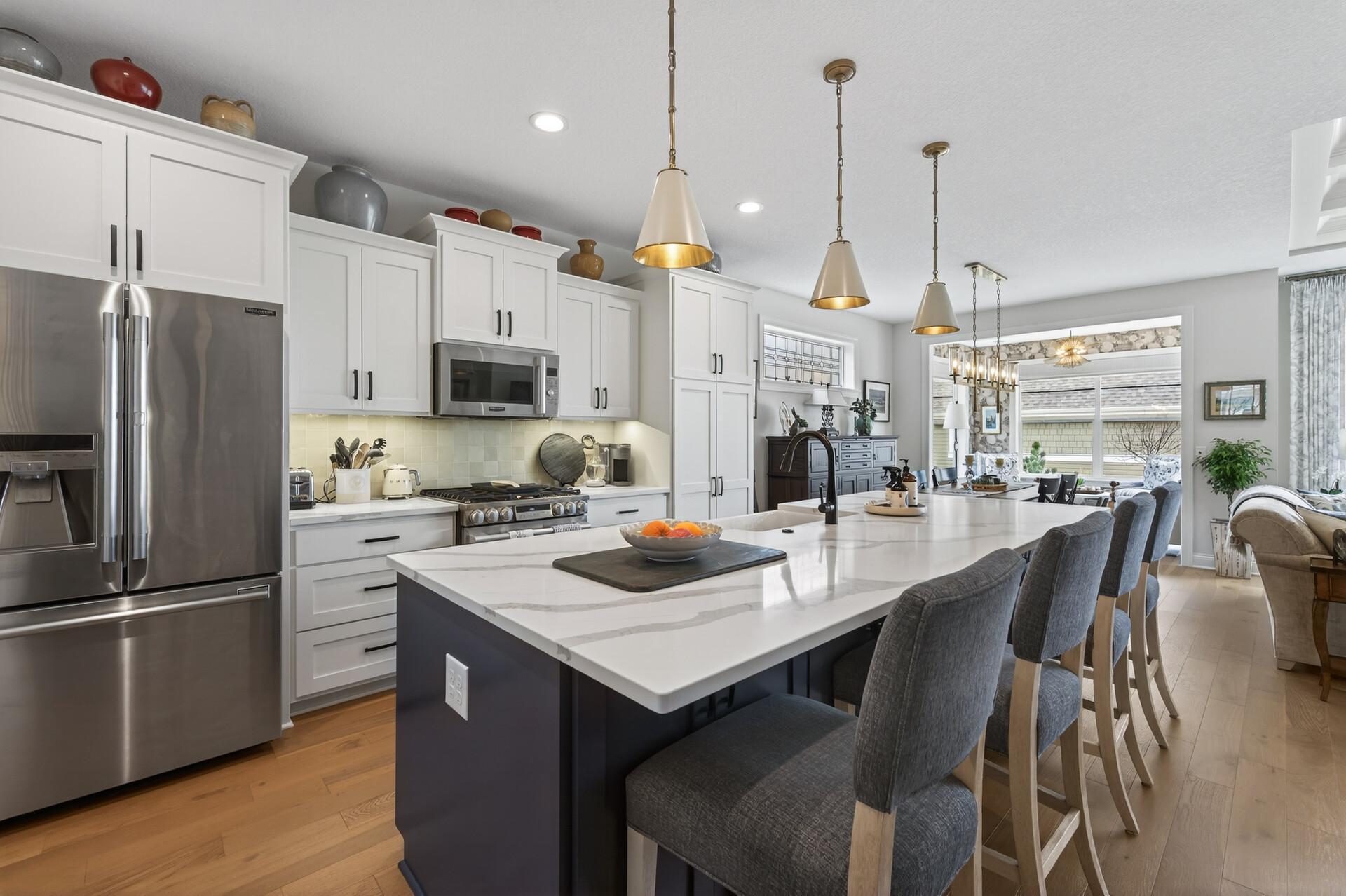 The chef's kitchen includes Kitchen Signature Luxury appliances, gas stove, quartz countertops, farm sink, and gorgeous lighting