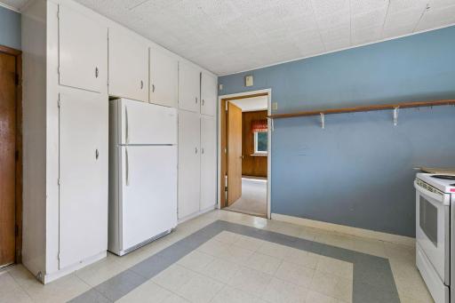 Kitchen flows into addition that could be used as main floor bedroom or flex living space