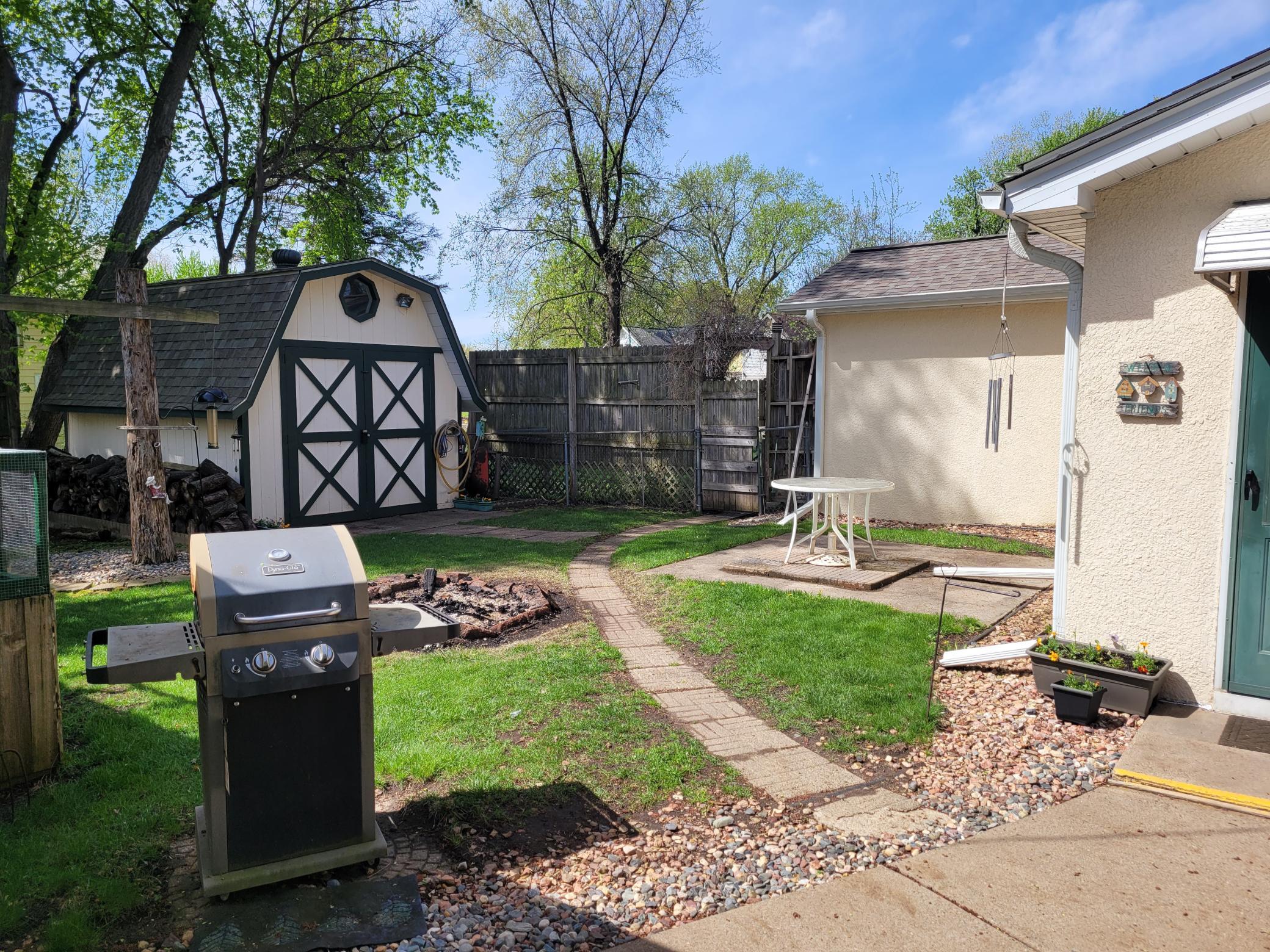 A look at the side back yard with patio and fire pit.