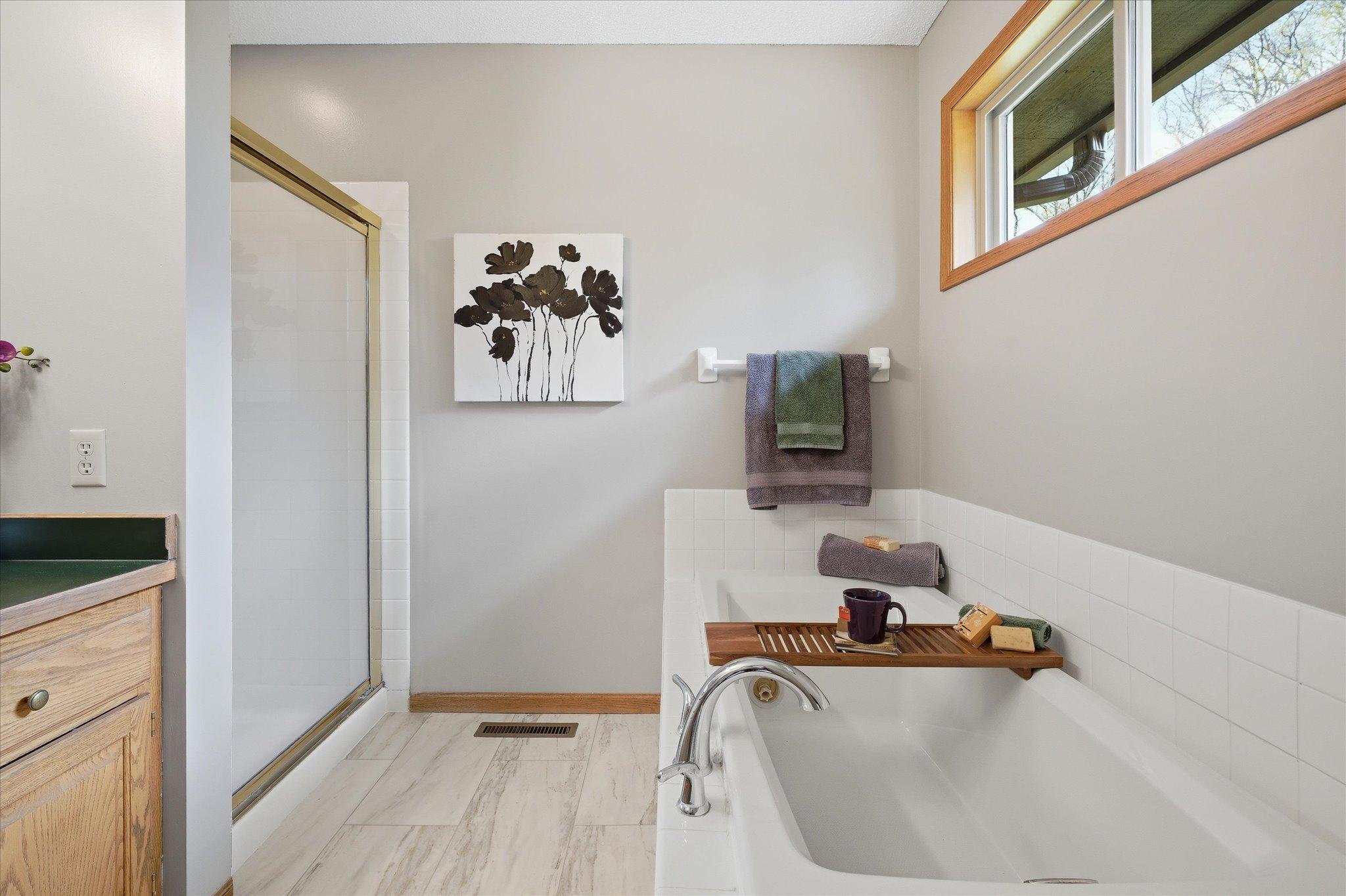 The shower and the tub both have a tile surround. And the tub has a new faucet too!